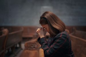 A,Christian,Girl,Is,Sitting,And,Praying,With,Humble,Heart